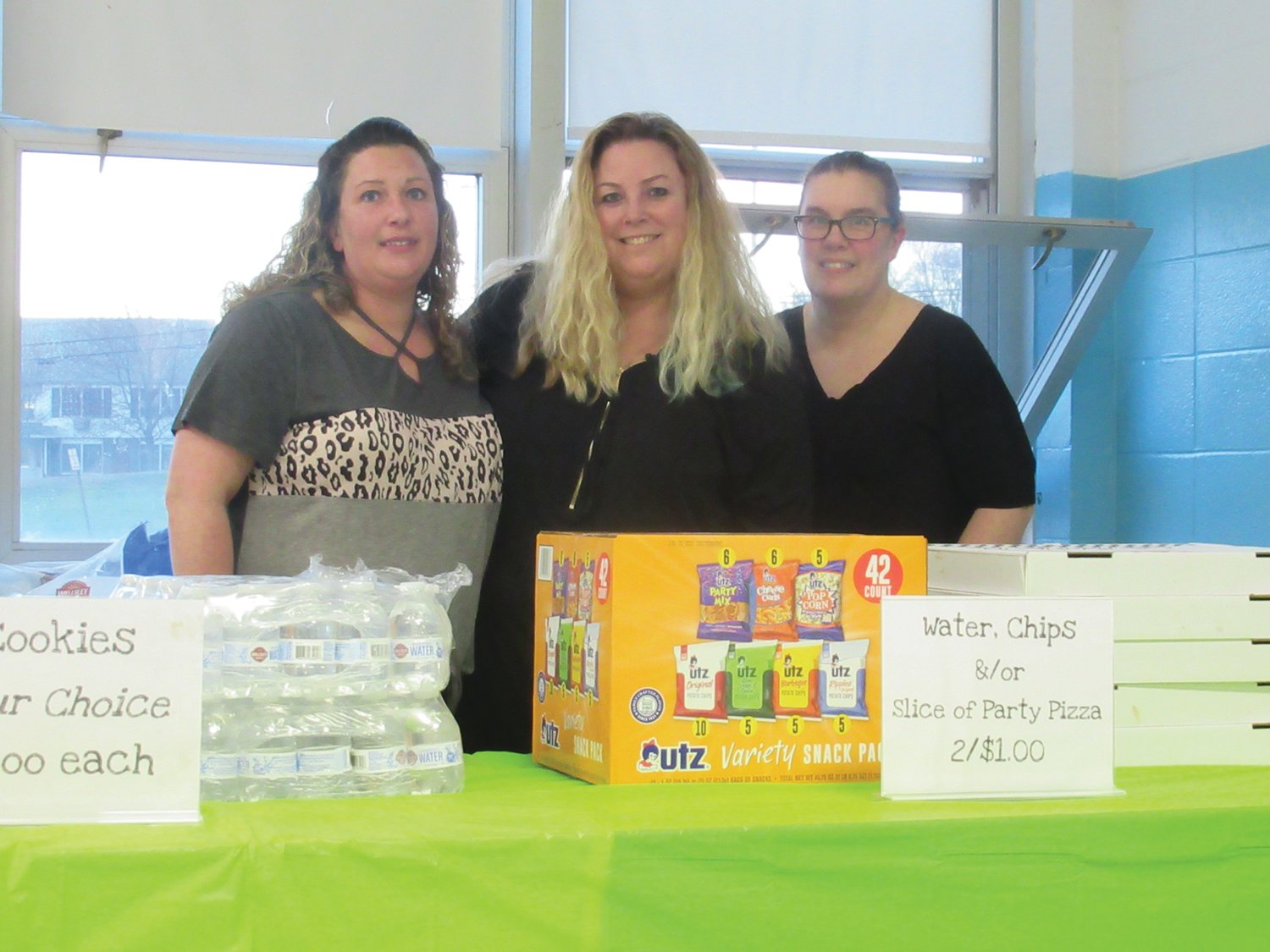 CARD CARRIERS: Dana Stonis, Kelley Cerbo-Charpentier and April Rose show off their bingo cards during last Friday’s fundraiser for Thornton Elementary School.